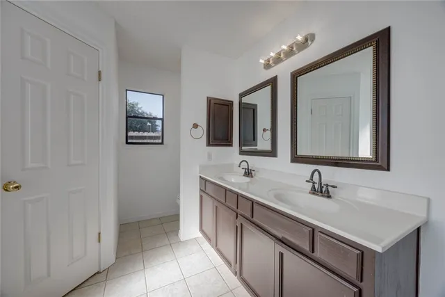 a bathroom with a double vanity sink and a mirror