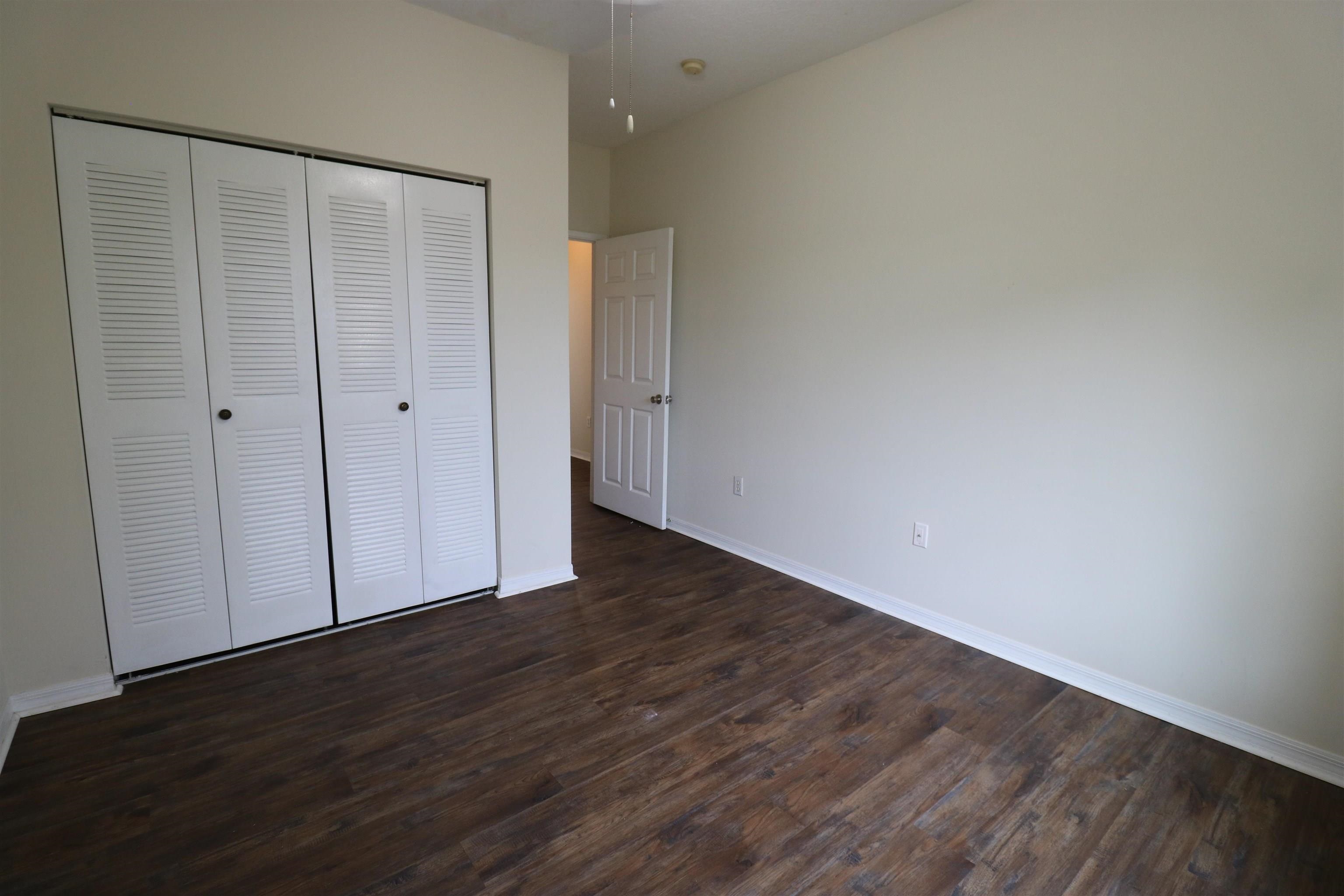 625 Fairway Drive, Unit 302 St. Augustine, FL 32084 - Photo 16 of 22 a view of an empty room with wooden floor