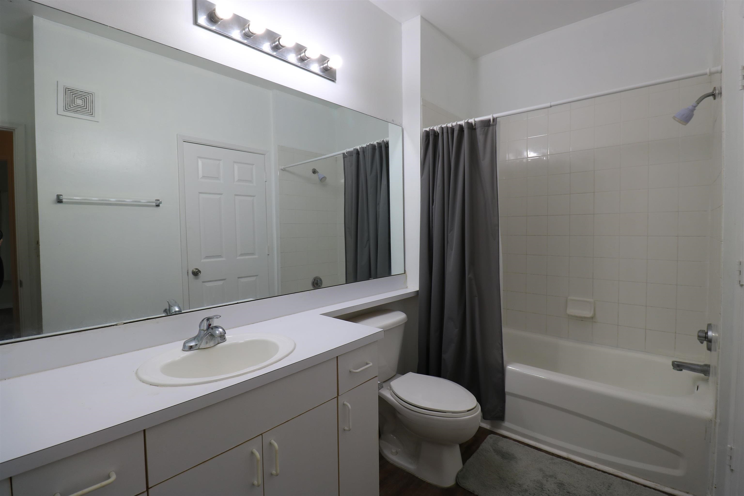 625 Fairway Drive, Unit 302 St. Augustine, FL 32084 - Photo 17 of 22 a bathroom with a sink a toilet and shower