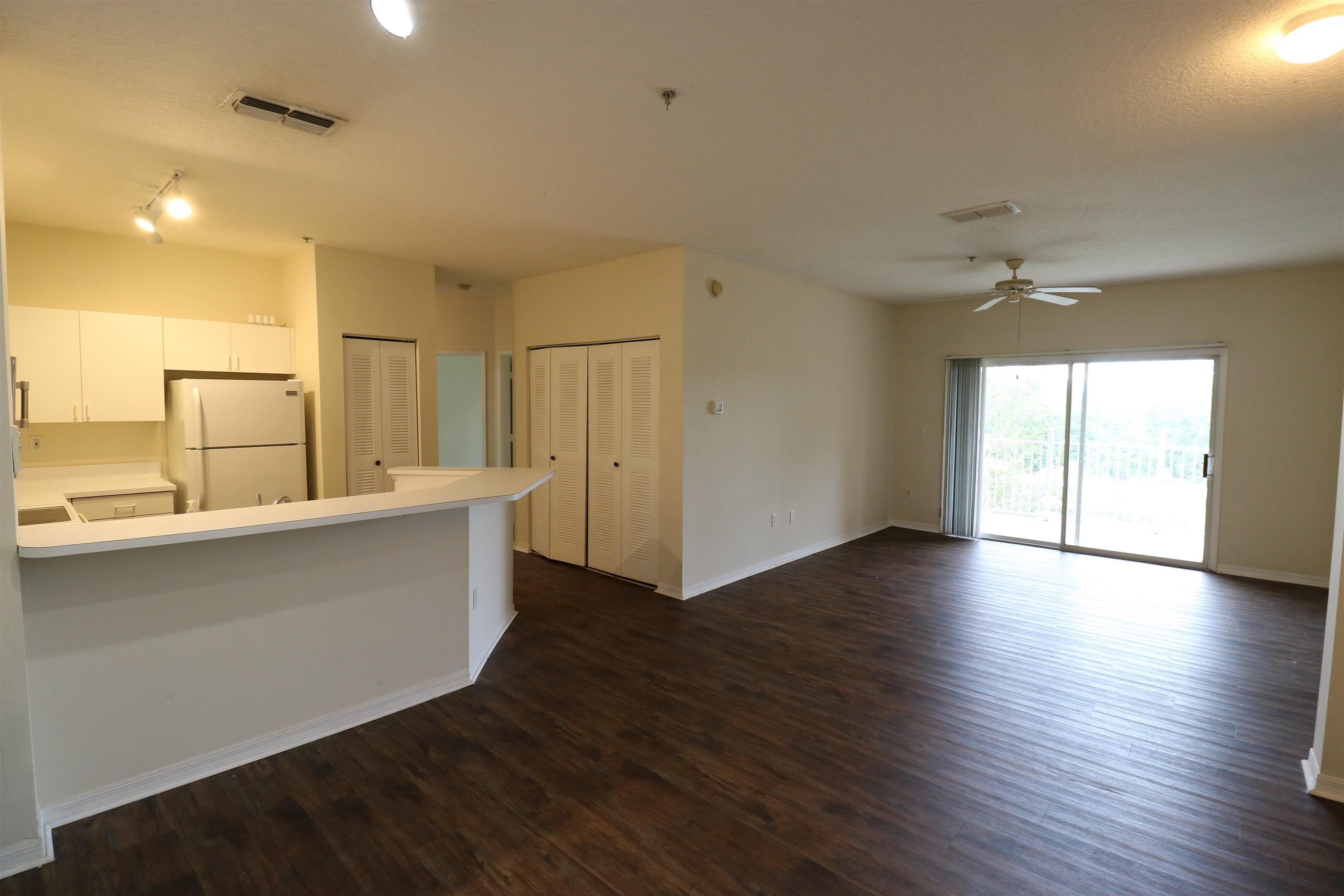 625 Fairway Drive, Unit 302 St. Augustine, FL 32084 - Photo 3 of 22 a view of a kitchen with wooden floor and a window