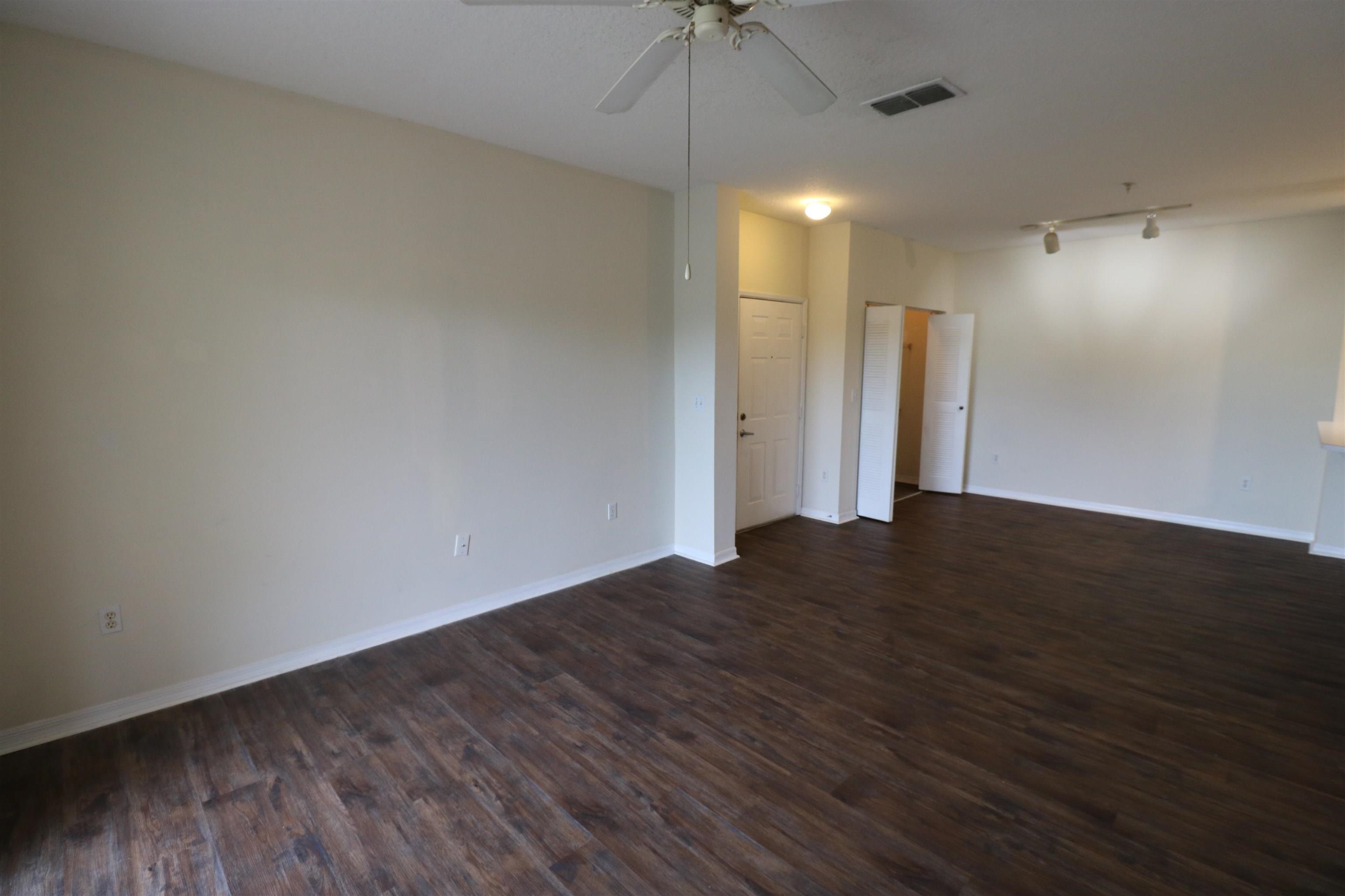 625 Fairway Drive, Unit 302 St. Augustine, FL 32084 - Photo 5 of 22 a view of an empty room with wooden floor