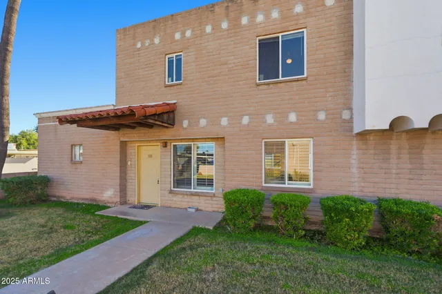 a front view of a house with a garden