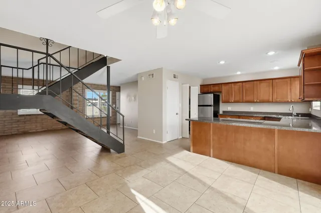a view of kitchen with cabinets and window