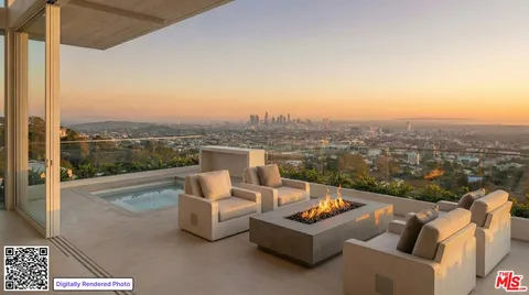 a view of a roof deck with couches and city view