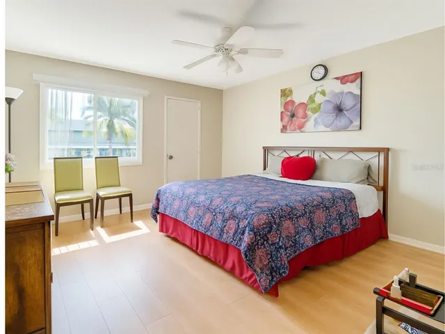 a spacious bedroom with a bed and a table in it