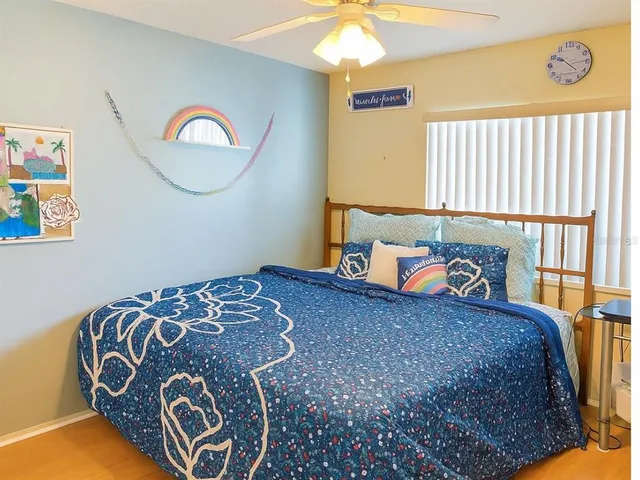 a bed sitting in a bedroom next to a window