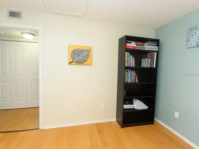 a room with a wooden floor and cabinets
