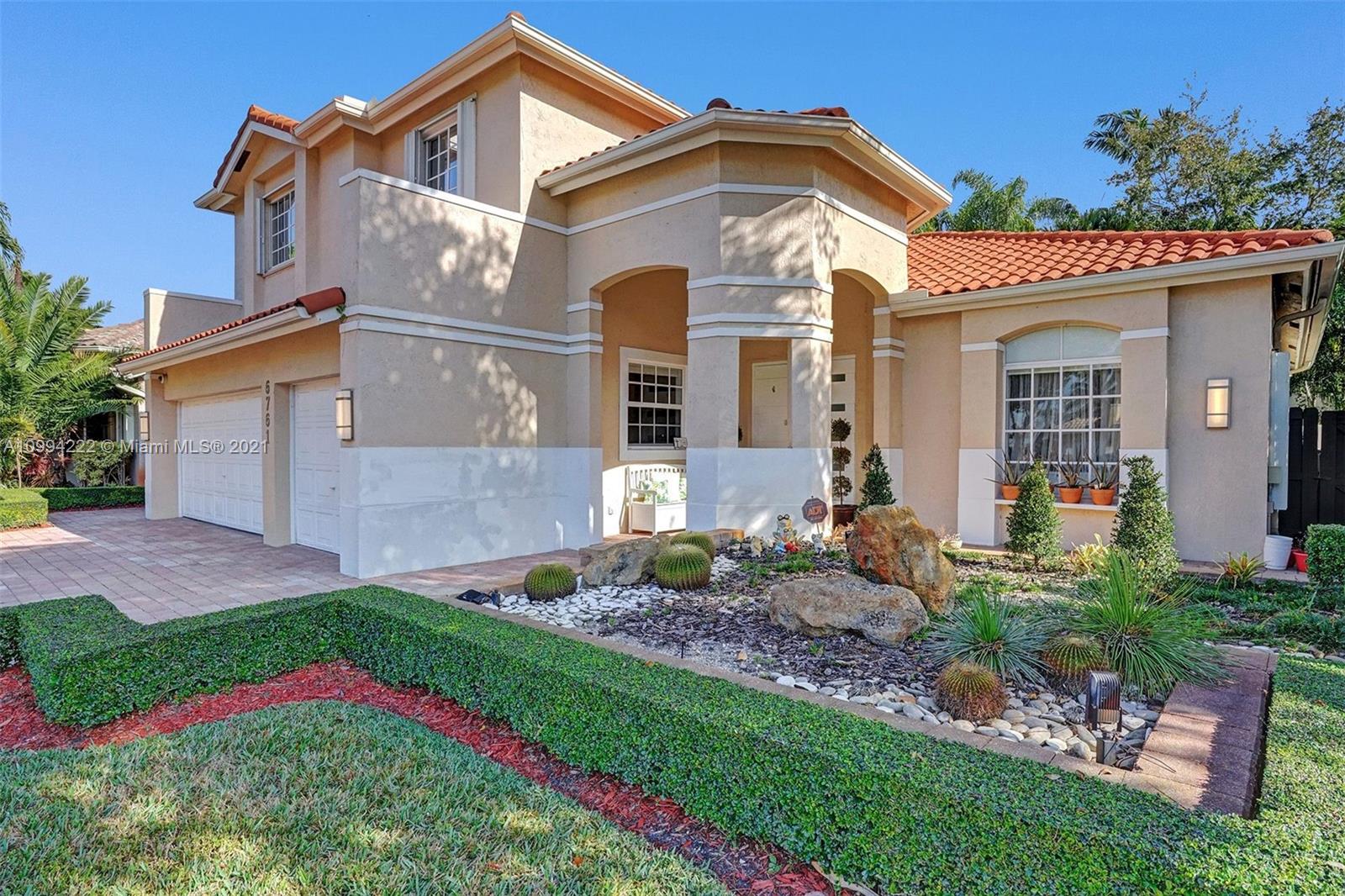 6761 Northwest 112th Avenue Doral, FL 33178 - Photo 4 of 55 a front view of a house with a yard
