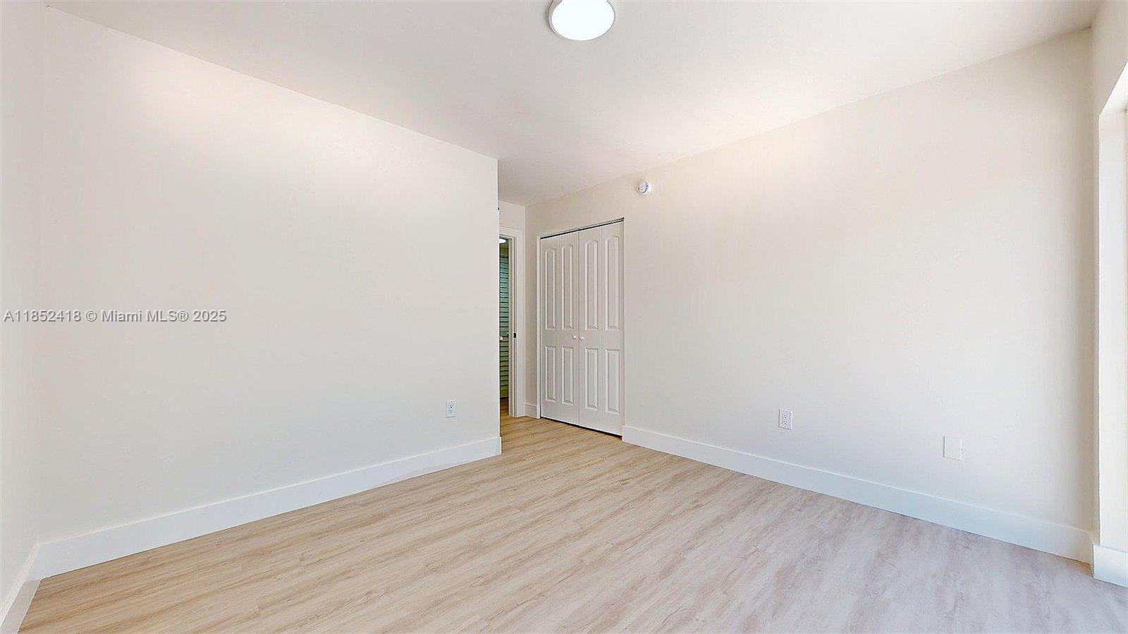 1674 West 42nd Street, Unit 1674 Hialeah, FL 33012 - Photo 15 of 29 a view of an empty room with wooden floor