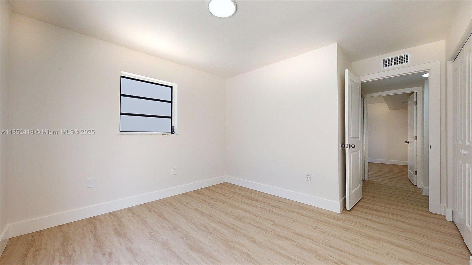 1674 West 42nd Street, Unit 1674 Hialeah, FL 33012 - Photo 16 of 29 wooden floor in an empty room