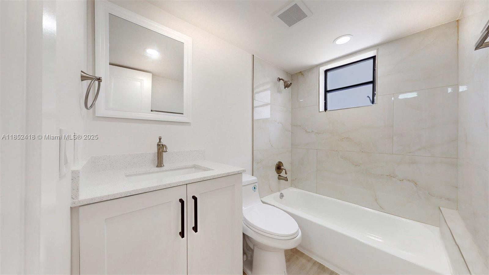 1674 West 42nd Street, Unit 1674 Hialeah, FL 33012 - Photo 18 of 29 a bathroom with a sink toilet a bathtub and shower