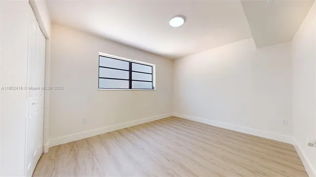 a bedroom with a bed and a potted plant