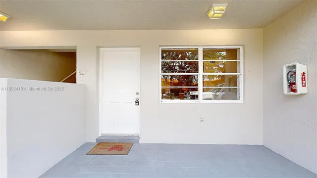 a view of a kitchen with white cabinets