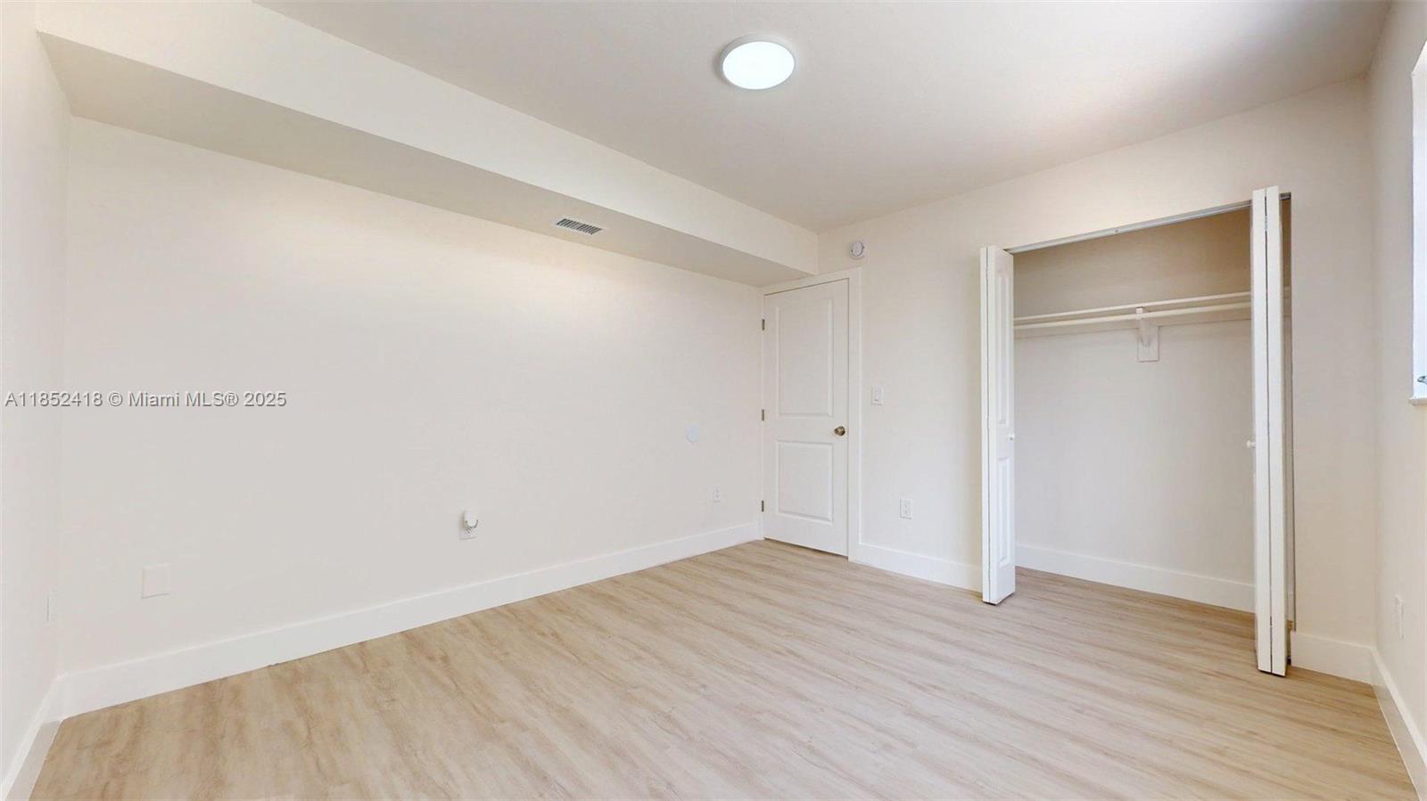 1674 West 42nd Street, Unit 1674 Hialeah, FL 33012 - Photo 21 of 29 wooden floor in an empty room