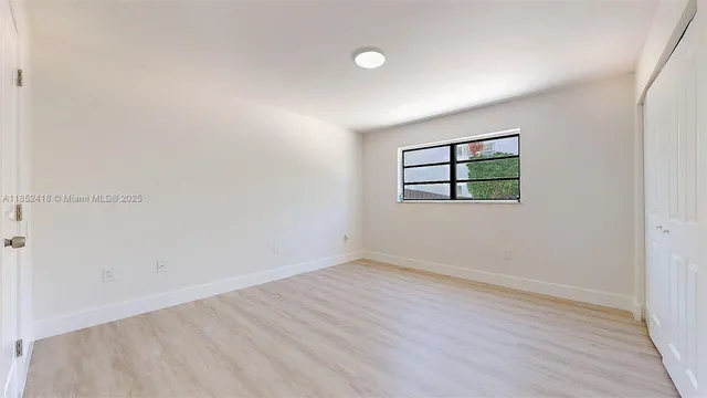 a bedroom with bed and a night stand