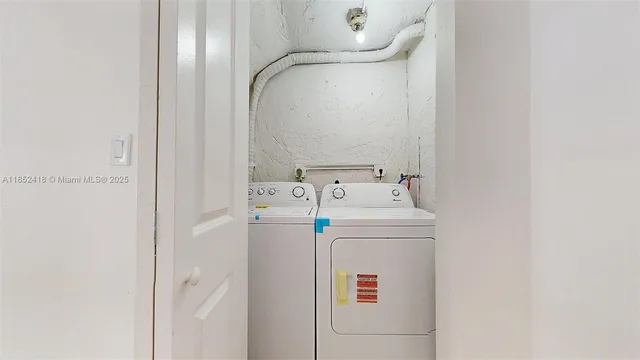 a kitchen with white cabinets and sink