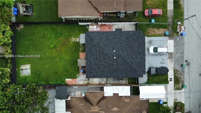 an aerial view of a house with a yard basket ball court and outdoor seating