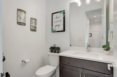 a bathroom with a sink toilet and a mirror