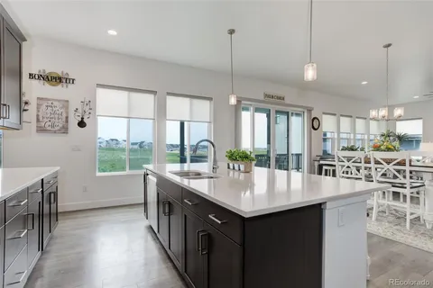 a large kitchen with kitchen island a large island in it