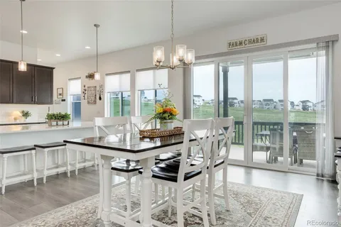 a living room with kitchen island furniture and a chandelier