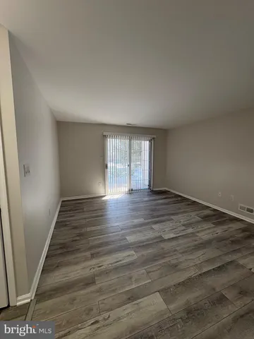 a view of wooden floor and windows in a room