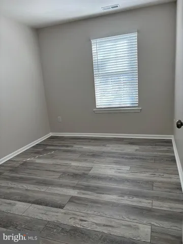 a room with a window and a wooden floor