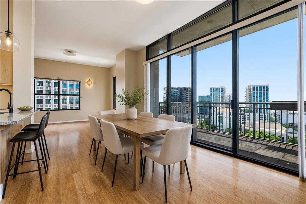 3040 Peachtree Road Northwest, Unit 1503 Atlanta, GA 30305 - Photo 2 of 38 a view of a dining room with furniture window and wooden floor