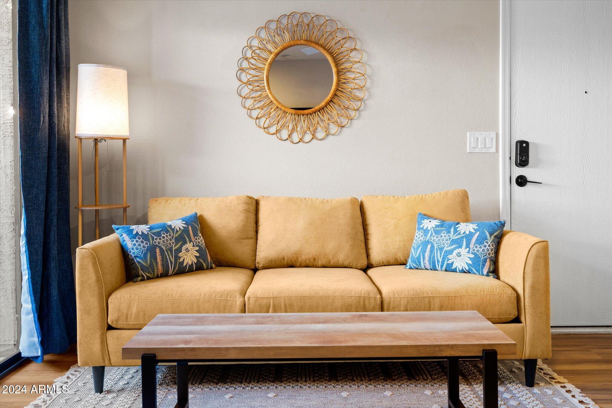 533 West Guadalupe Road, Unit 1063 Mesa, AZ 85210 - Photo 6 of 57 a blue couch sitting in a living room next to a lamp