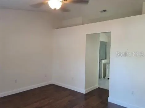 an empty room with wooden floor and closet