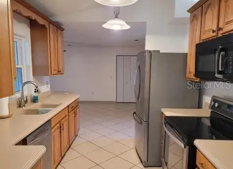 a kitchen with a sink appliances and cabinets