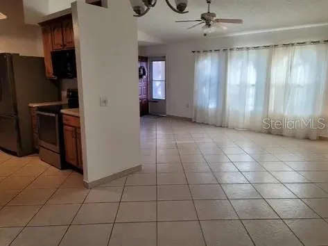 a view of a livingroom with an empty space and a window