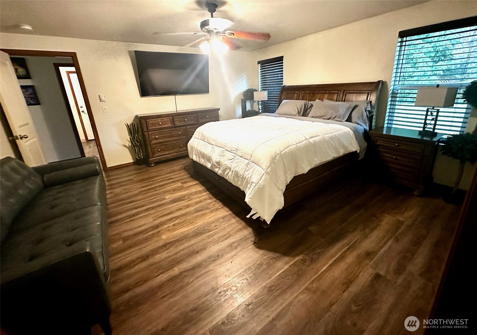 381 Elk Valley Road Forks, WA 98331 - Photo 12 of 26 a bedroom with a bed a mirror on dresser and a flat screen tv