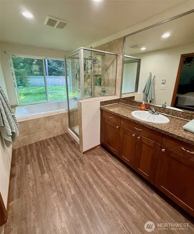 a spacious bathroom with a granite countertop sink and a large mirror
