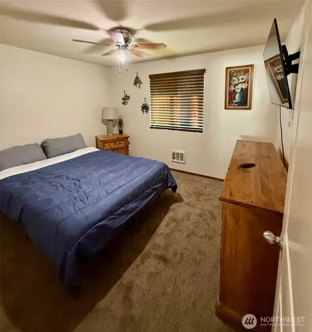 a bedroom with a bed dresser and a window