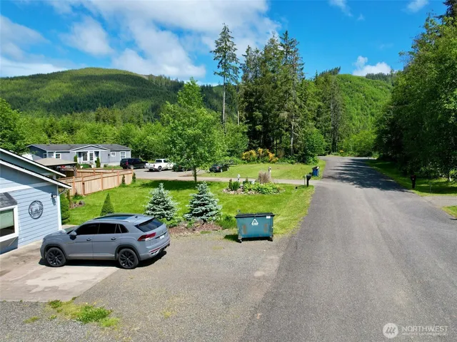 a car parked in front of a house with a yard