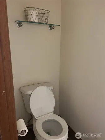 a white toilet sitting next to a bathroom sink
