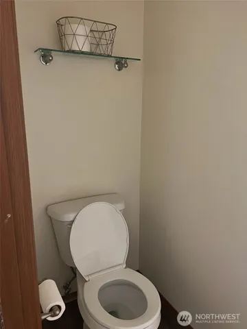 a white toilet sitting next to a bathroom sink
