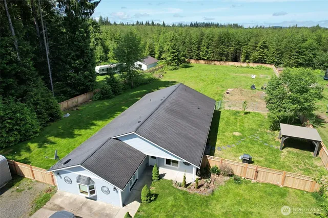 an aerial view of a house with a yard