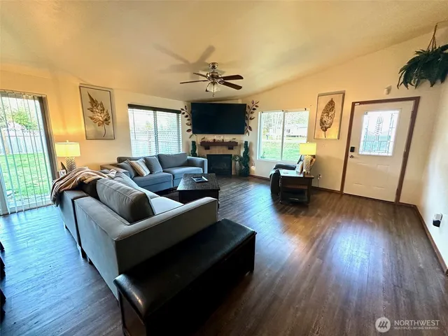 a living room with fireplace furniture and a flat screen tv