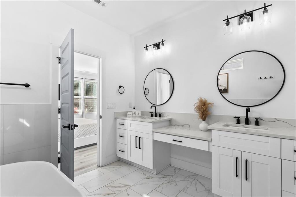 658 Rockbridge Road Northwest Lilburn, GA 30047 - Photo 14 of 61 a bathroom with a double vanity sink mirror and toilet