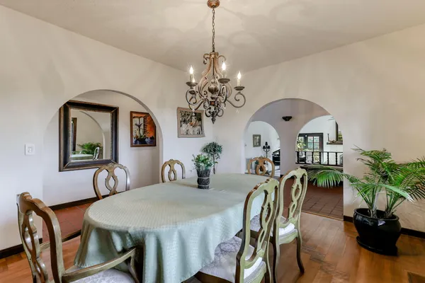 a view of a dining room with furniture and a chandelier