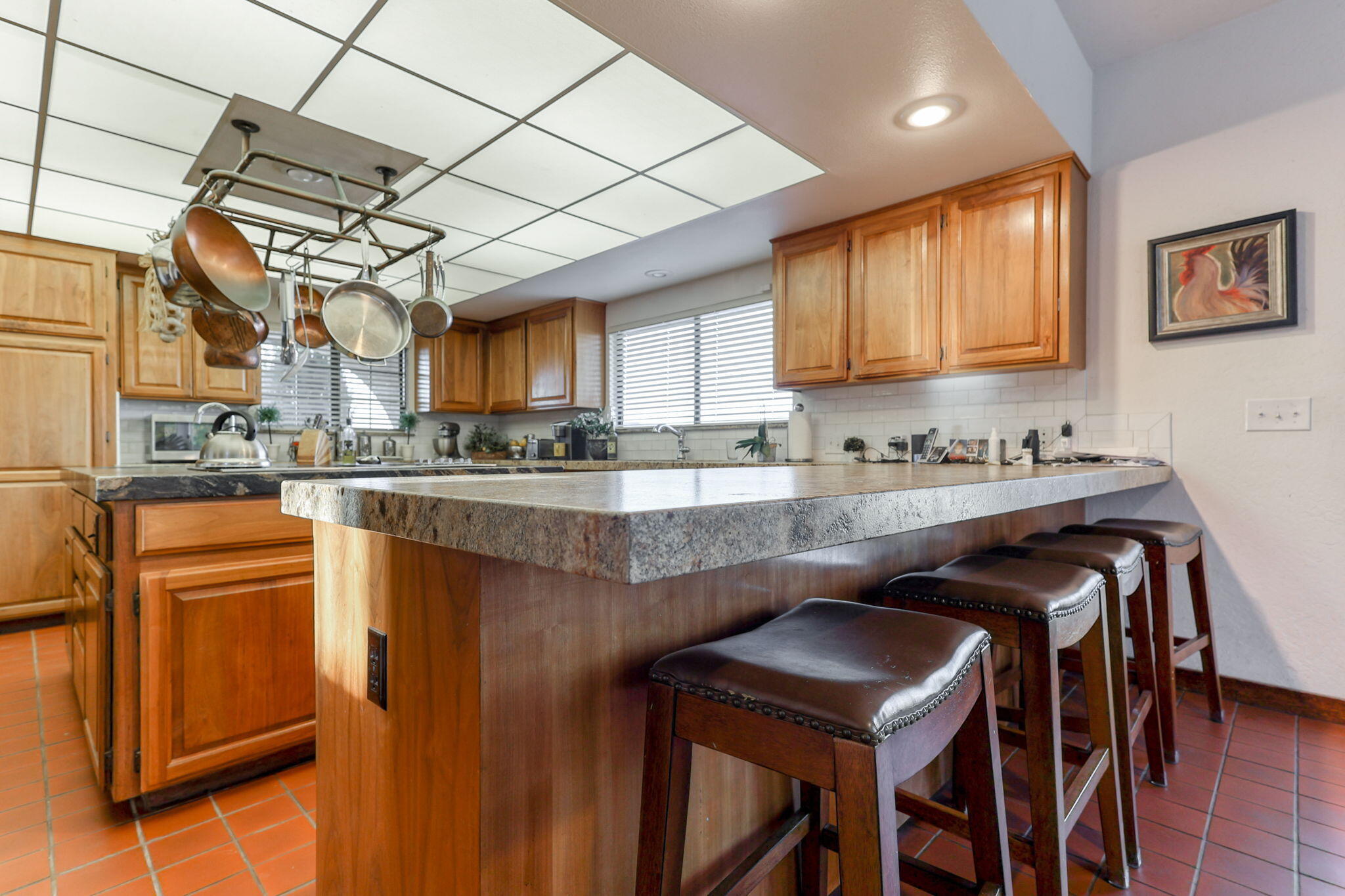 22797 Silverlode Lane Palo Cedro, CA 96073 - Photo 28 of 64 a kitchen with stainless steel appliances granite countertop a stove a refrigerator a sink dishwasher and white cabinets with wooden floor