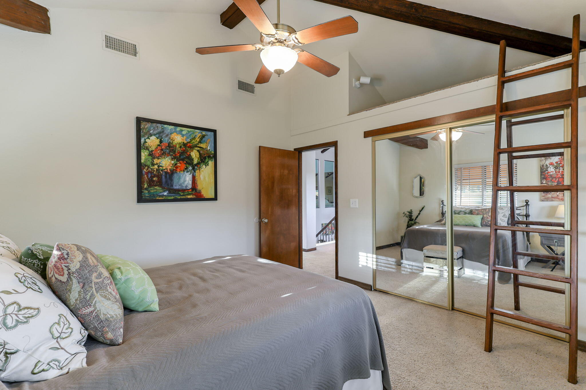 22797 Silverlode Lane Palo Cedro, CA 96073 - Photo 32 of 64 a bedroom with a bed mirror and a large window
