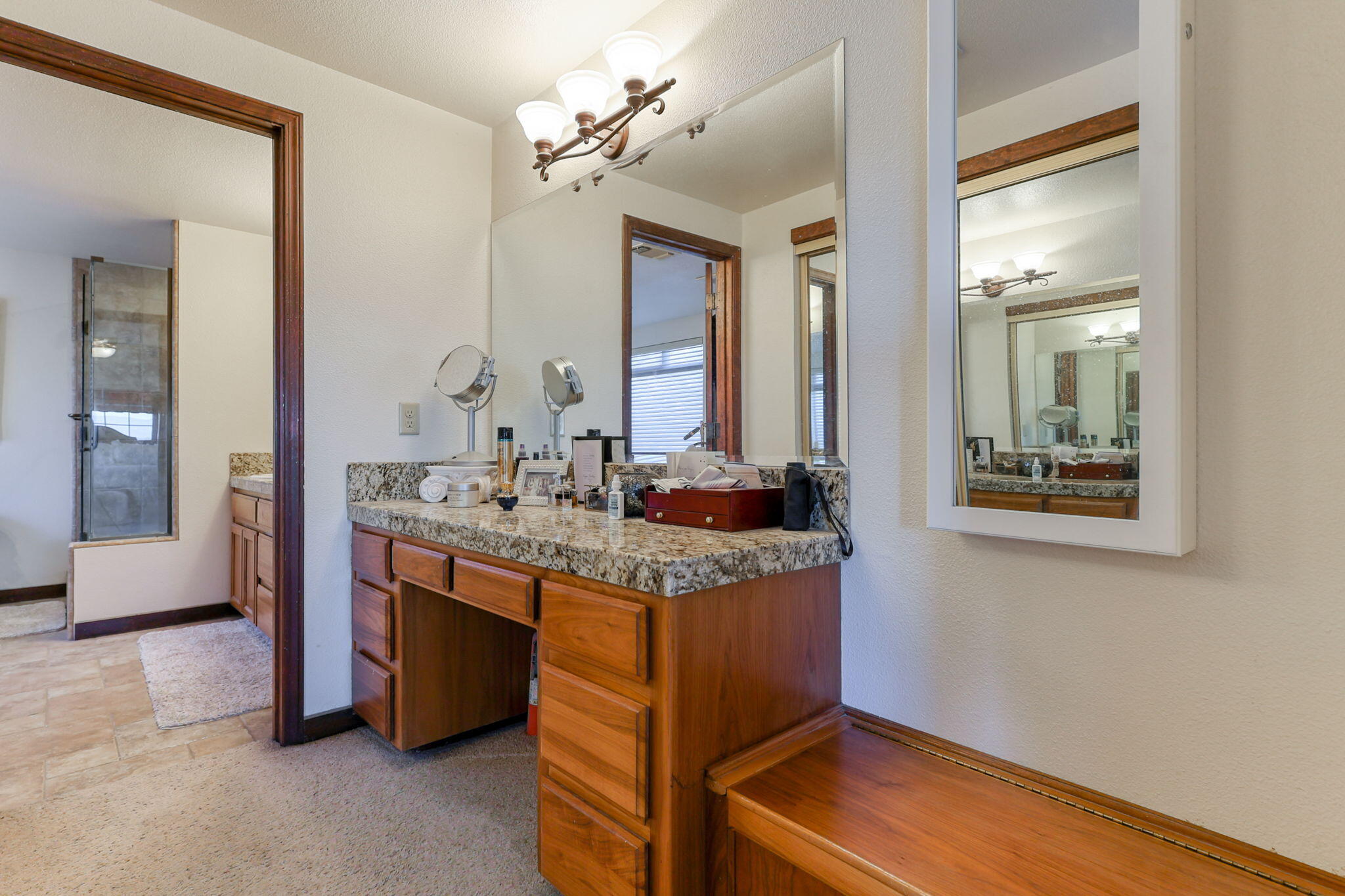 22797 Silverlode Lane Palo Cedro, CA 96073 - Photo 45 of 64 a bathroom with a granite countertop sink and a mirror