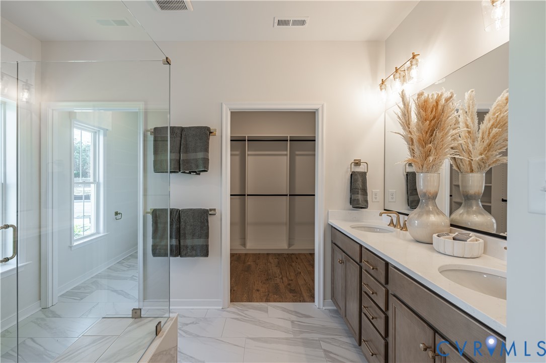 6607 Mayland Rdg Lane; Moseley, VA 23120 - Photo 11 of 15 a bathroom with a double sink shower and mirror