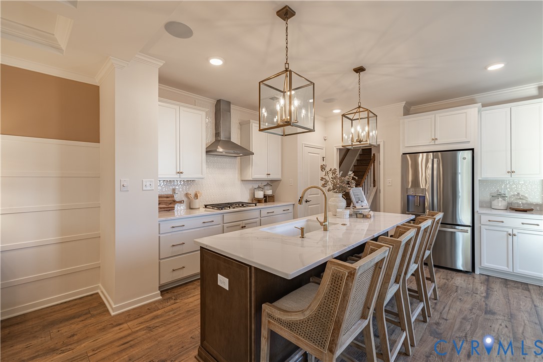 6607 Mayland Rdg Lane; Moseley, VA 23120 - Photo 5 of 15 a kitchen with stainless steel appliances a dining table chairs stove refrigerator and cabinets