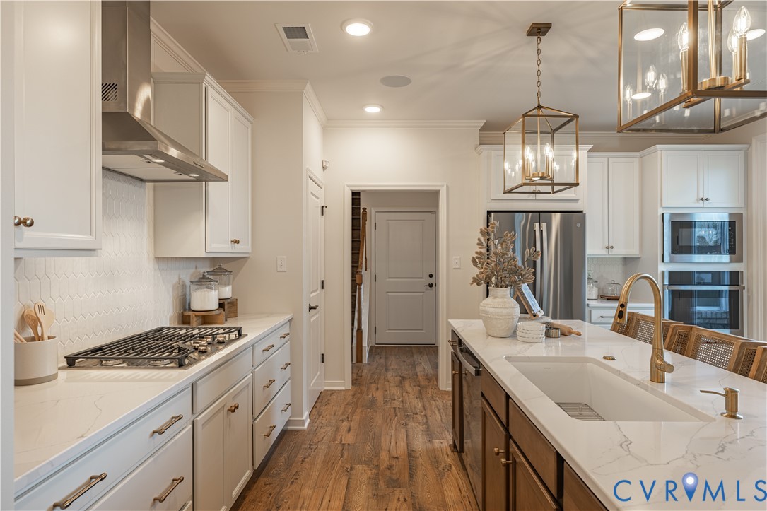 6607 Mayland Rdg Lane; Moseley, VA 23120 - Photo 6 of 15 a kitchen with stainless steel appliances a sink stove and refrigerator