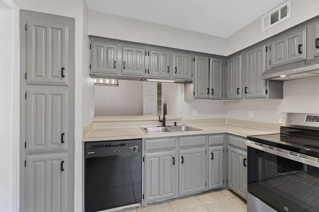 a kitchen with a sink dishwasher and cabinets