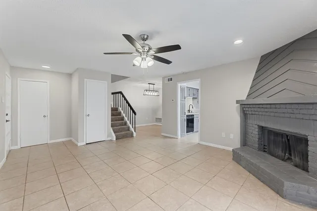 a view of an empty room with a fireplace