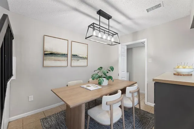 a view of a dining room with a table and chairs